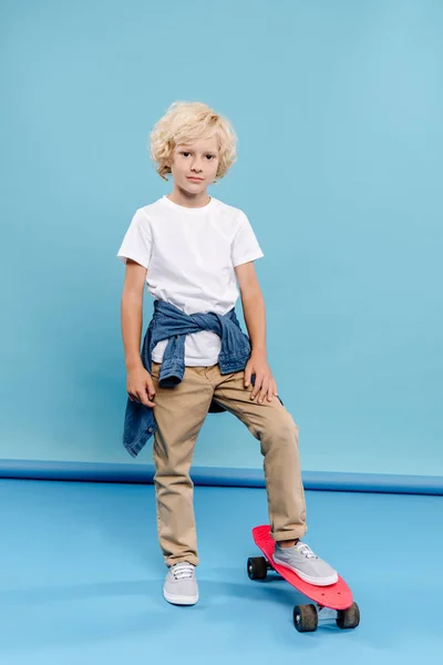 Cute Kid Looking Camera Standing Penny Board Blue Background — Stock Photo, Image