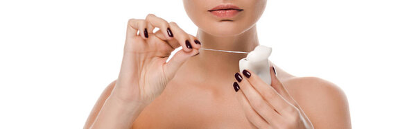 panoramic shot of naked woman holding dental floss isolated on white 