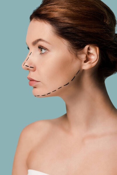 young woman with marked lines on face looking away isolated on blue 