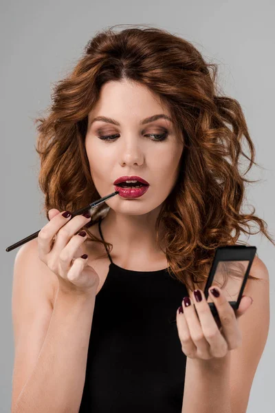 Attractive Curly Woman Holding Cosmetic Brush Lips Isolated Grey — ストック写真