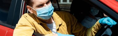 man in medical mask and protective gloves driving taxi during coronavirus pandemic, website header clipart