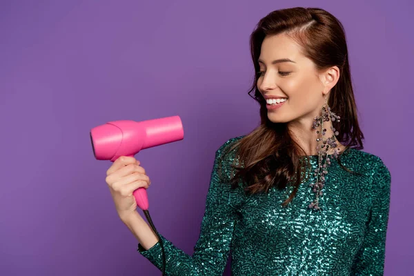 Young Happy Woman Looking Pink Hair Dryer Isolated Purple — Stock Photo, Image