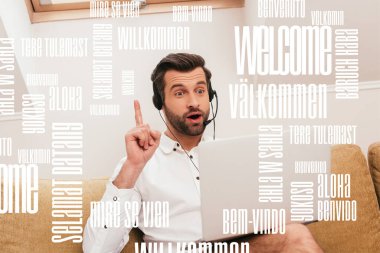 Selective focus of excited freelancer in headset showing idea gesture during video chat on laptop at home, translation illustration clipart