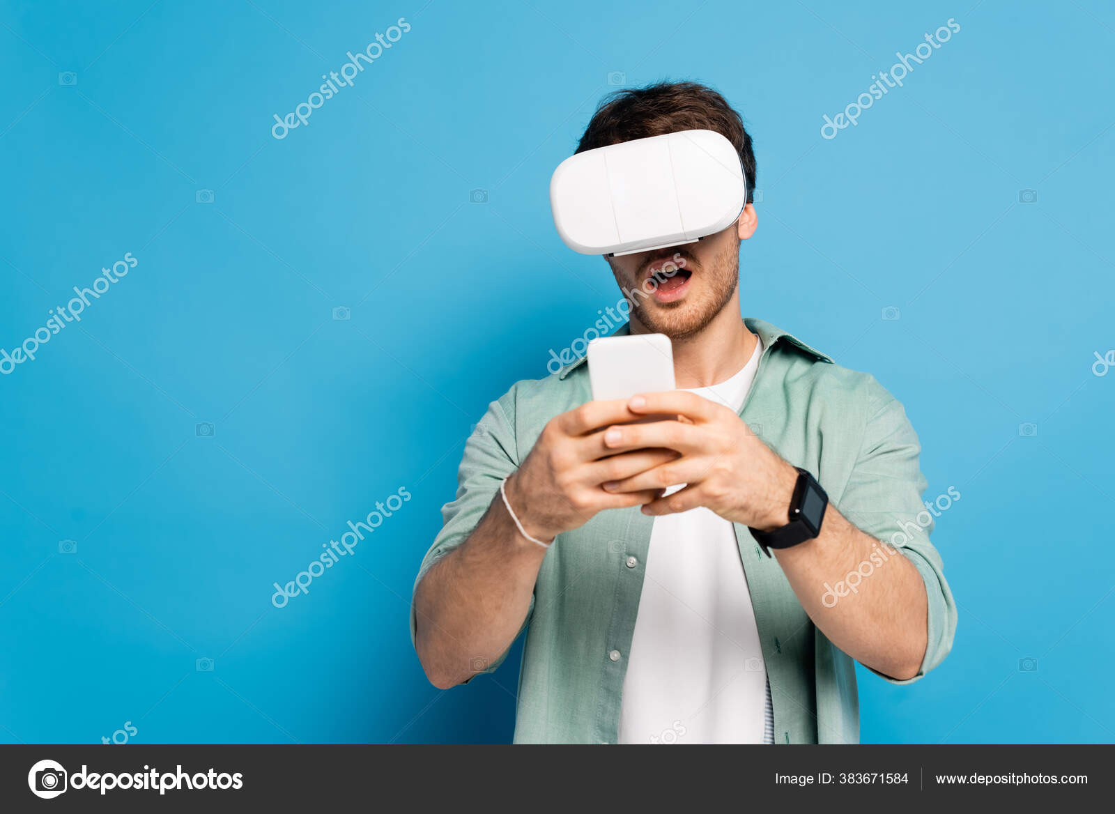 Shocked Young Man Headset Using Smartphone Blue Stock Photo by