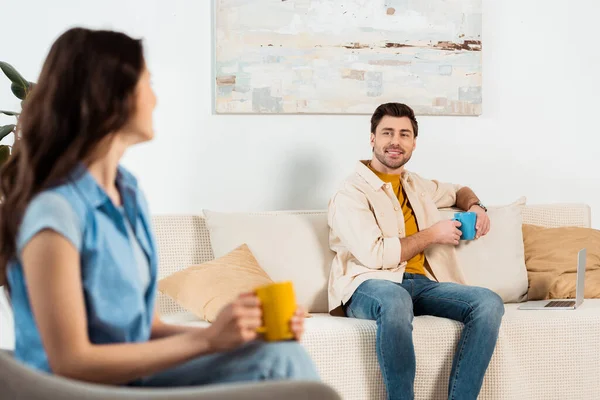 Selective Focus Man Holding Cup Coffee Laptop Smiling Girlfriend Living — Stock Photo, Image