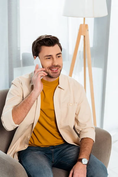 Handsome Man Smiling While Talking Smartphone Armchair — Stock Photo, Image
