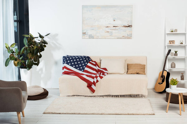 Interior of living room with american flag on couch 