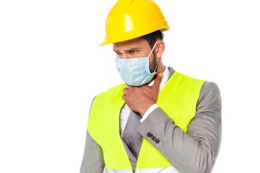 Sapka ve tıbbi maske takan hasta mühendis beyaz boyuna dokunuyor.