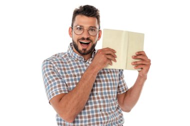 Cheerful nerd in eyeglasses holding open book isolated on white clipart
