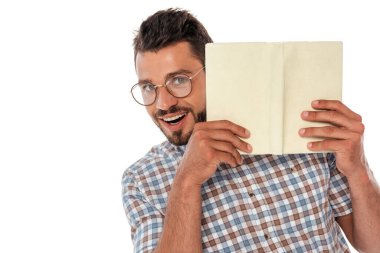 Smiling nerd in eyeglasses holding open book isolated on white clipart