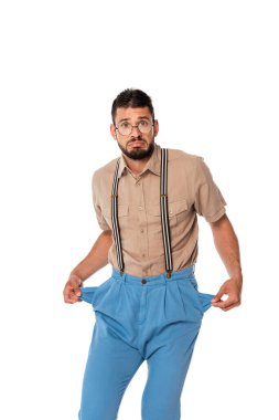 Confused nerd looking at camera while showing empty pockets of pants isolated on white clipart
