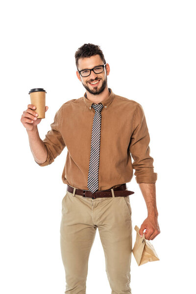 Smiling teacher holding paper cup and bag isolated on white