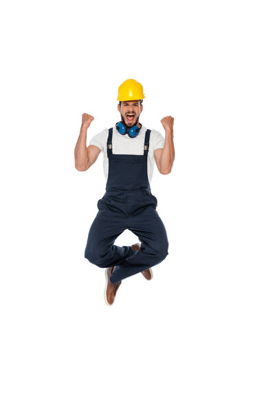 Excited builder in uniform showing yeah gesture isolated on white