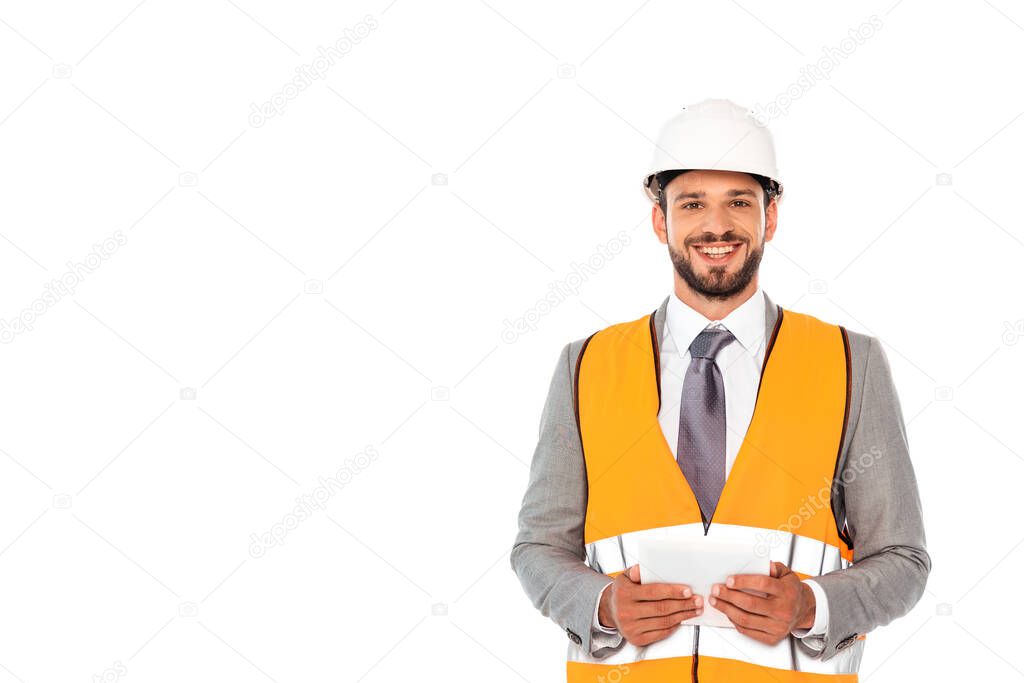 Smiling engineer in suit and hardhat holding digital tablet isolated on white