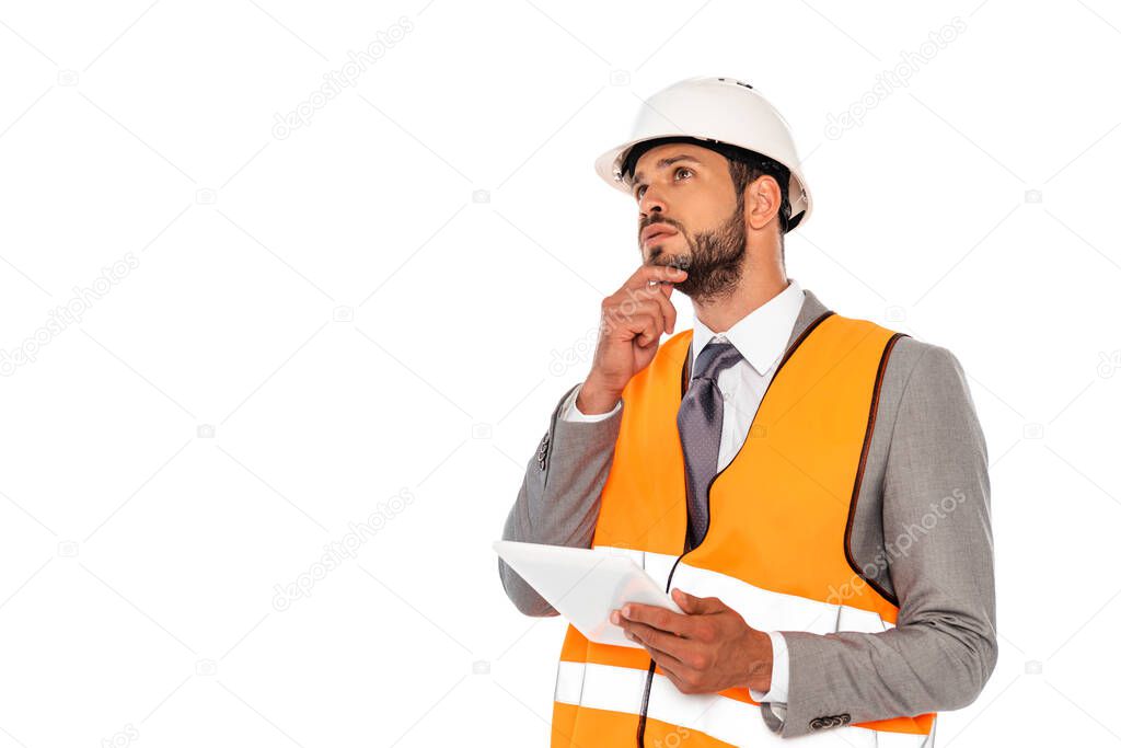 Pensive engineer in suit and hardhat holding digital tablet isolated on white