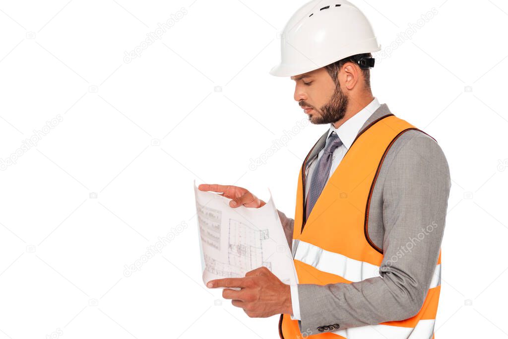 Engineer in safety helmet and suit looking at blueprint isolated on white