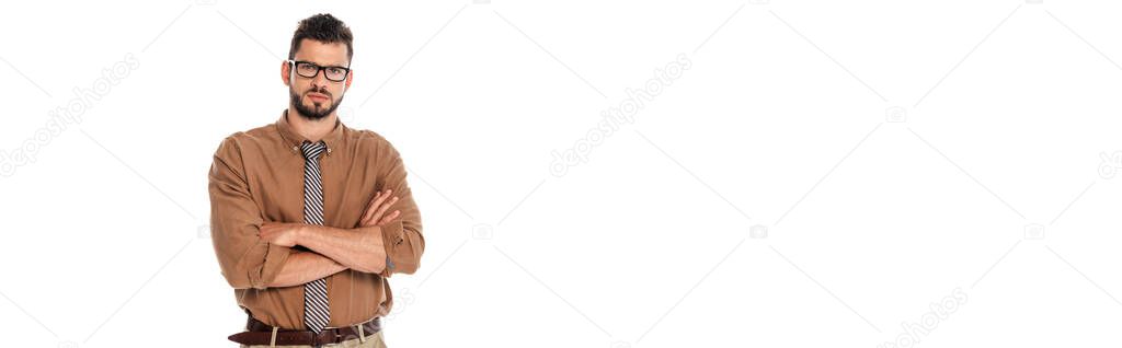 Panoramic shot of serious teacher with crossed arms looking at camera isolated on white
