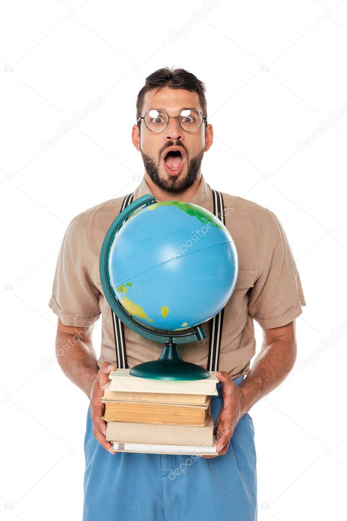 Shocked nerd looking at camera while holding globe and books isolated on white
