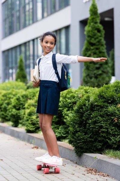 Happy African American Schoolgirl Backpack Books Riding Penny Board Outdoors — Stock Photo, Image