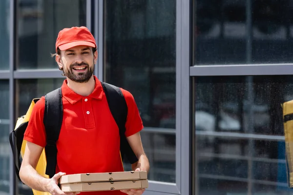 Positiv Leverans Man Tittar Kameran Medan Håller Pizza Lådor Nära — Stockfoto