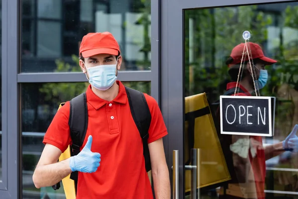 Courier Medical Mask Showing Thumb Signboard Open Lettering Door Building — Stock Photo, Image