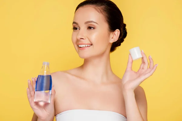 Smiling Beautiful Woman Holding Micellar Water Bottle Isolated Yellow — Stock Photo, Image