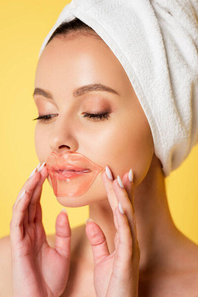 naked beautiful woman with towel on head, lip patch isolated on yellow