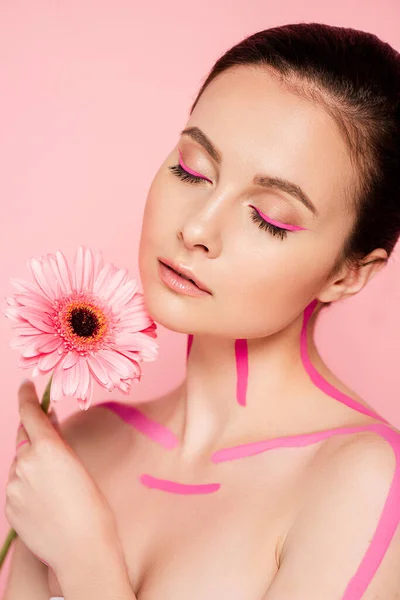 naked beautiful woman with pink lines on body and flower isolated on pink