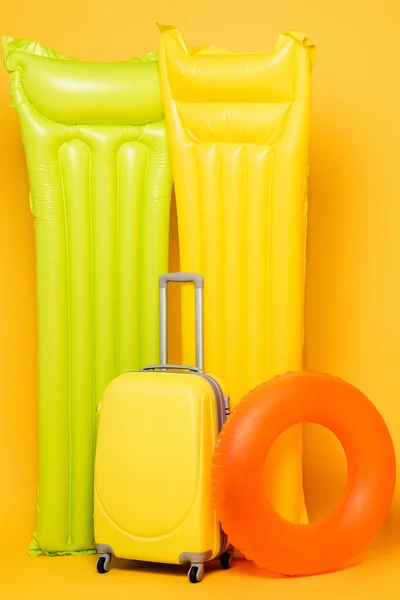 Travel Bag Pool Floats Yellow Background — Stock Photo, Image