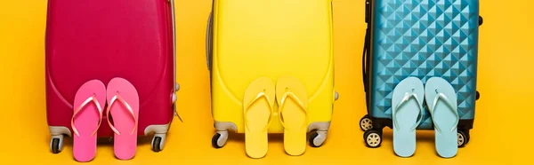 Yellow Pink Blue Travel Bags Flip Flops Isolated Yellow Panoramic — Stock Photo, Image