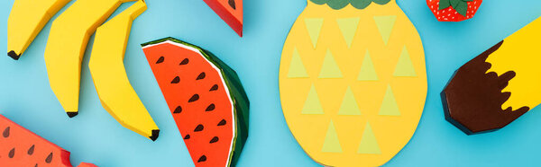 top view of paper summer fruits and ice cream on blue background, panoramic shot