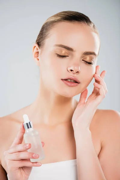 Attractive Woman Closed Eyes Holding Bottle Serum Touching Face Isolated — Stock Photo, Image