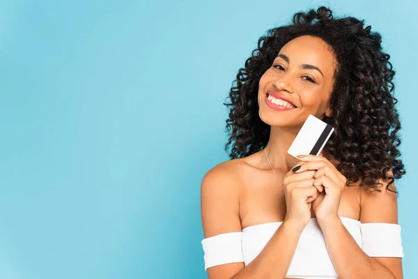 Cheerful Curly African American Woman Holding Credit Card Isolated Blue — Stock Photo, Image