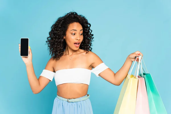 Shocked African American Woman Holding Shopping Bags Smartphone Blank Screen — Stock Photo, Image