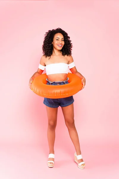 Smiling African American Woman Holding Swim Ring While Standing Pink — Stock Photo, Image
