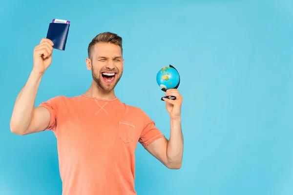 Excited Bearded Man Closed Eyes Holding Passport Globe Isolated Blue — Stock Photo, Image