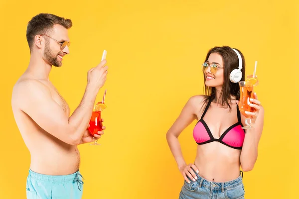 Bearded Man Taking Photo Happy Girl Headphones Cocktail Isolated Yellow — Stock Photo, Image