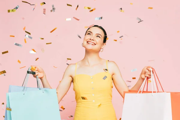 Brunette Young Woman Shopping Bags Falling Confetti Isolated Pink — Stock Photo, Image