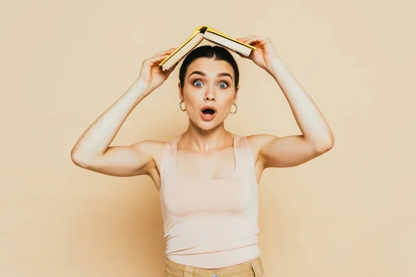 Shocked Brunette Young Woman Book Head Beige — Stock Photo, Image