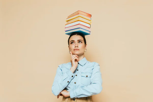 Pensive Student Denim Skjorta Med Böcker Huvudet Isolerad Beige — Stockfoto