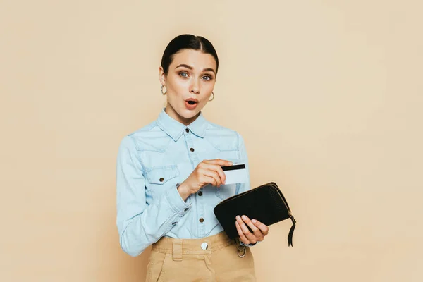 Shocked Brunette Woman Denim Shirt Holding Wallet Credit Card Isolated — Stock Photo, Image