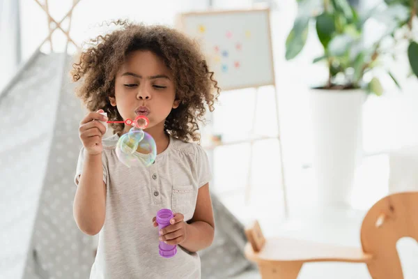 Curly African American Kid Blowing Soap Bubbles — Stock Photo, Image