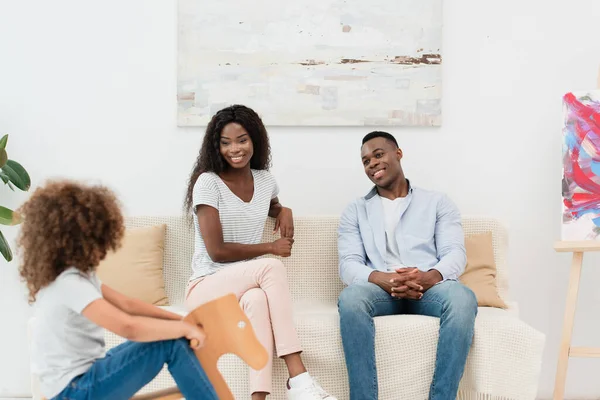 Selective Focus African American Parents Looking Kid Sitting Rocking Horse — Stock Photo, Image