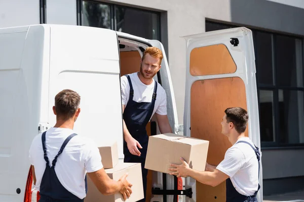 Selective Focus Loader Looking Colleague Cardboard Boxes While Unloading Truck — Stock Photo, Image