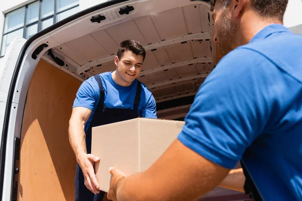 Selective Focus Loader Holding Cardboard Box Colleague Truck Urban Street — Stock Photo, Image