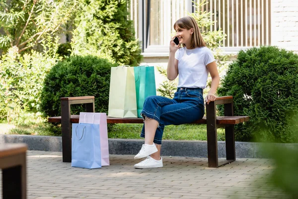 Selective Focus Woman Talking Smartphone Shopping Bags Bench Urban Street — Stock Photo, Image