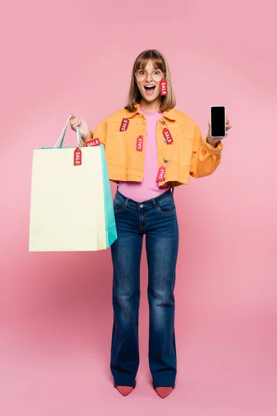 Excited Woman Holding Smartphone Blank Screen Shopping Bags Price Tags — Stock Photo, Image