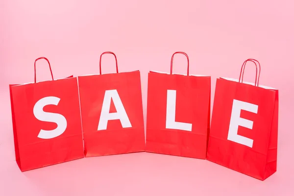 Red Shopping Bags Sale Lettering Pink Surface — Stock Photo, Image