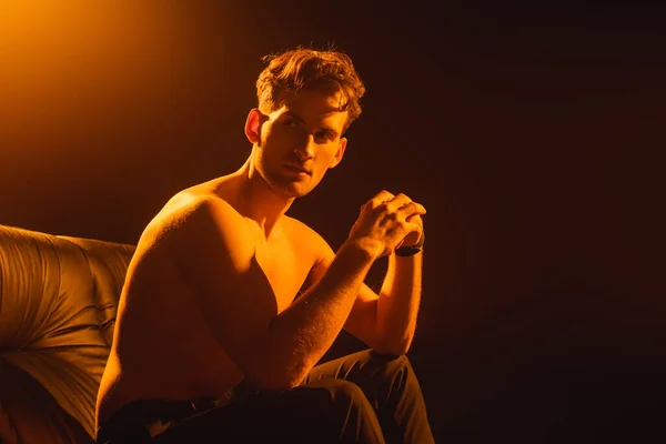 Shirtless Man Looking Away While Sitting Sofa Black — Stock Photo, Image