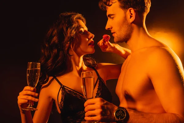 Seductive Woman Holding Fresh Strawberry Shirtless Man Glass Champagne Black — Stock Photo, Image